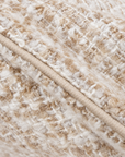 Close-up of ivory body pillow fabric with textured woven pattern and trim