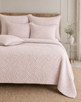 Quilted blush bedding set with textured duvet cover and two square shams