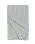 Sea glass textured throw with diagonal fold and waffle-knit surface