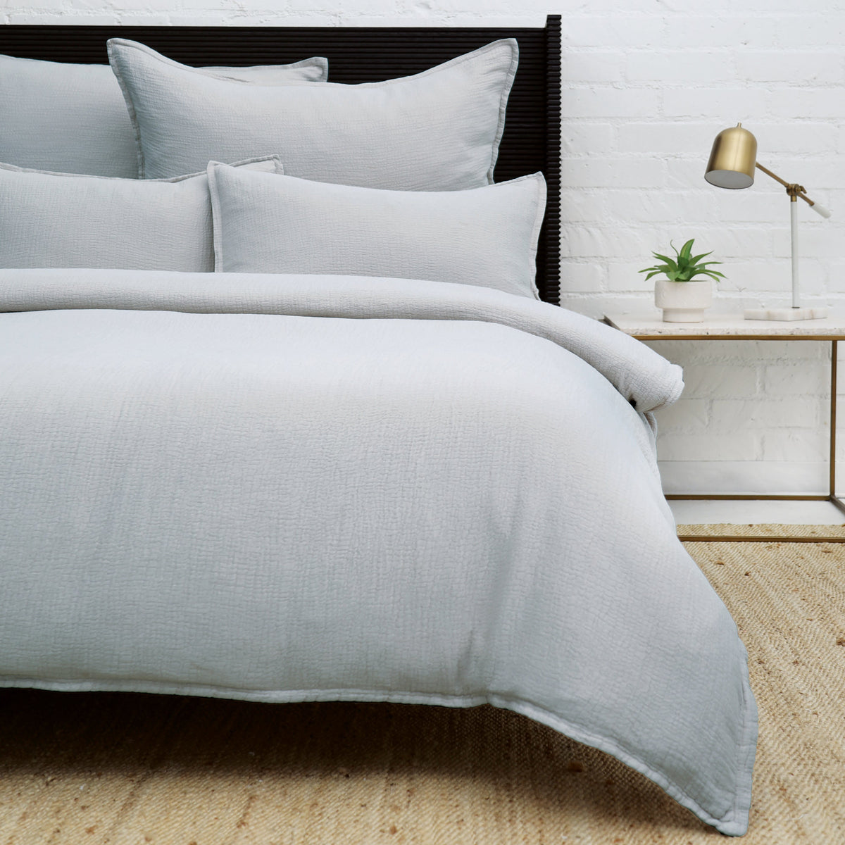 Set of rectangular throw pillows with insert, light blue bedding on bed