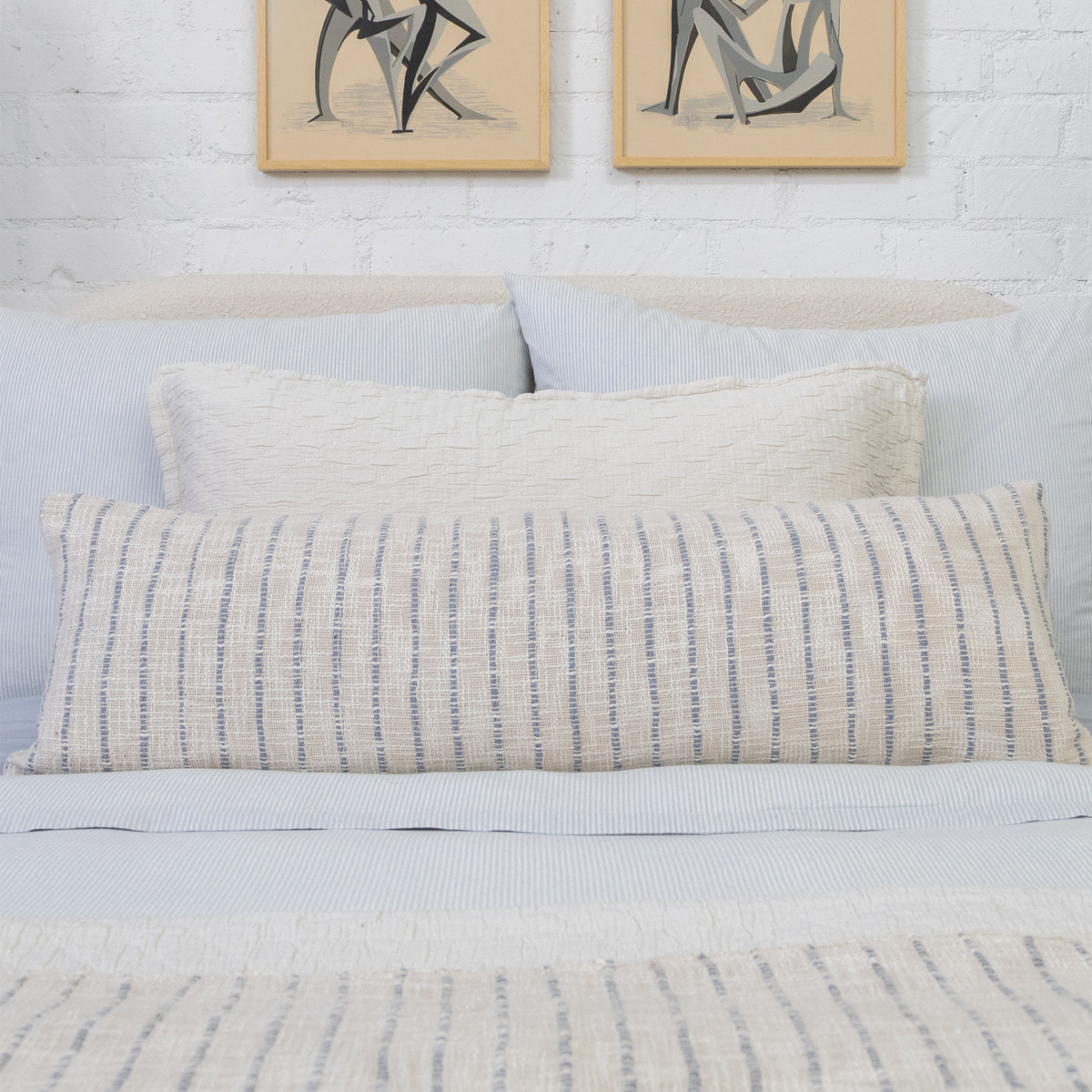 Stacked bedding with 14x40 lumbar pillow with insert in ivory and blue-gray striped fabric