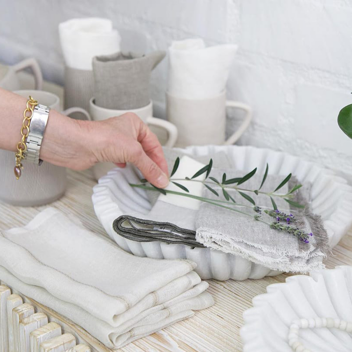 White cloth napkins with scalloped edge and small floral embroidery
