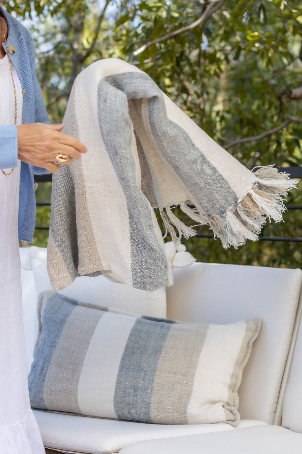 Oversized striped throw with cream and light blue bands and tasseled fringe