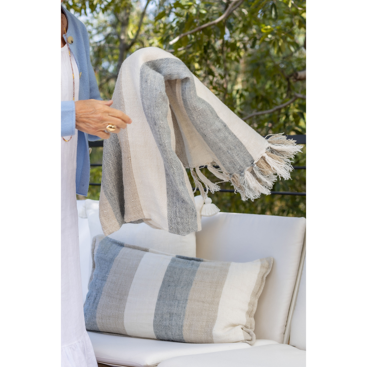 Rectangular striped throw pillow with fringe trim on the edges