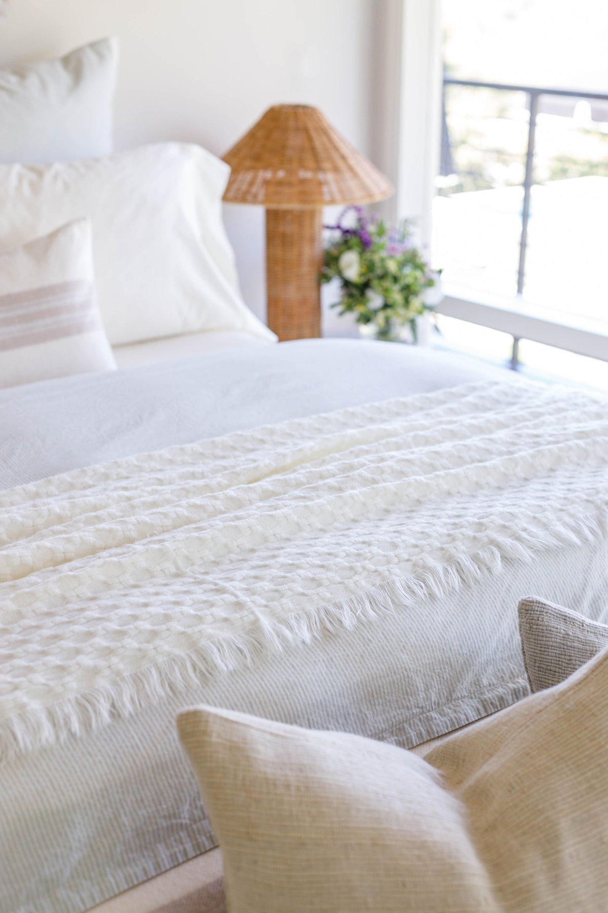 Ivory oversized throw blanket with textured weave and fringed edge