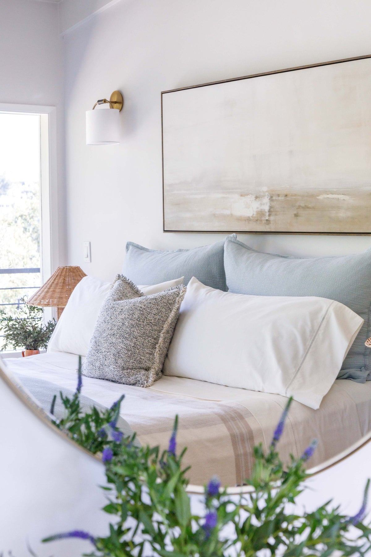 20x20 textured pillow with insert, light gray, placed on bed with white bedding.