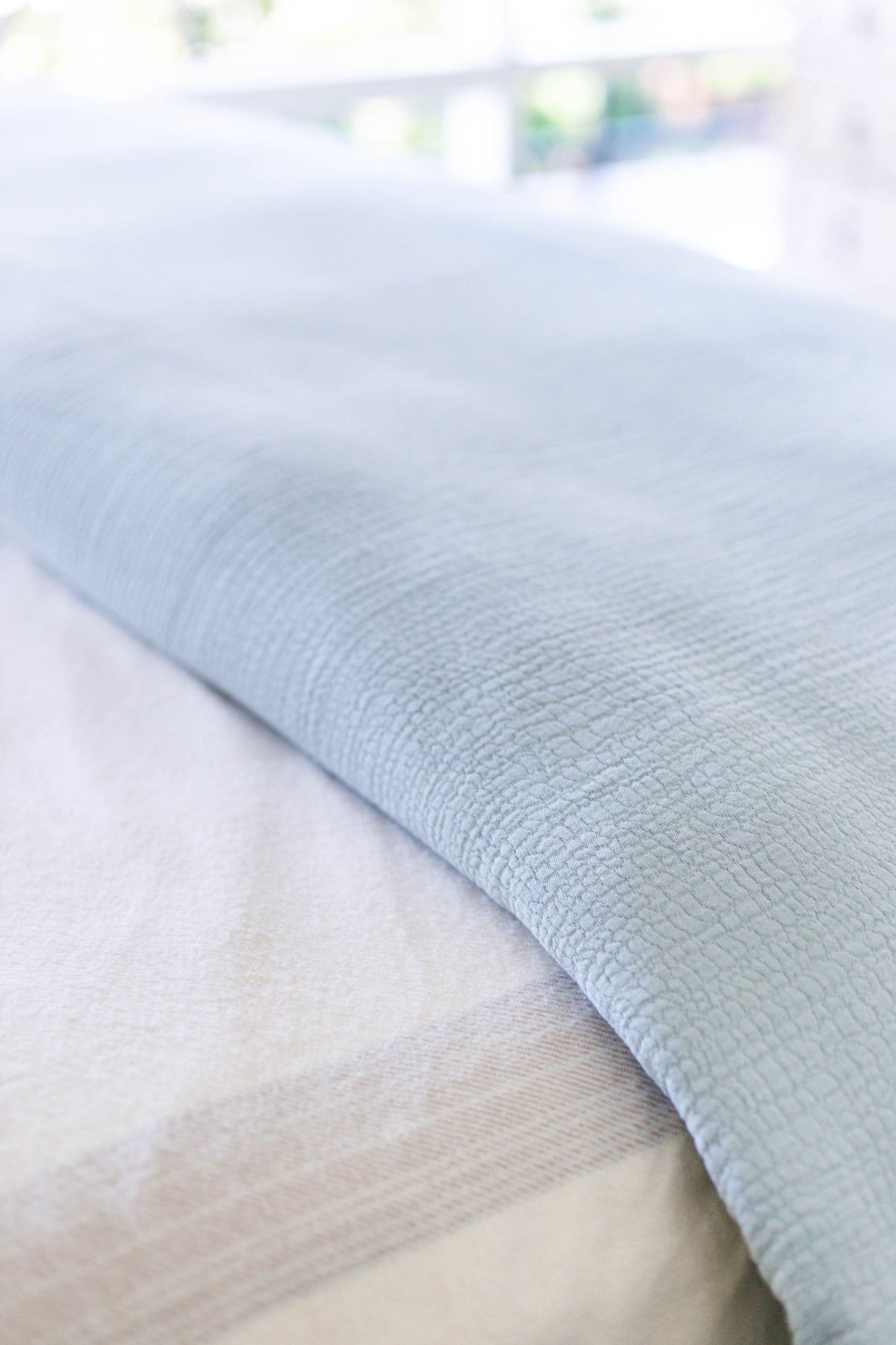 Sea glass cotton duvet fabric close-up with subtle textured weave