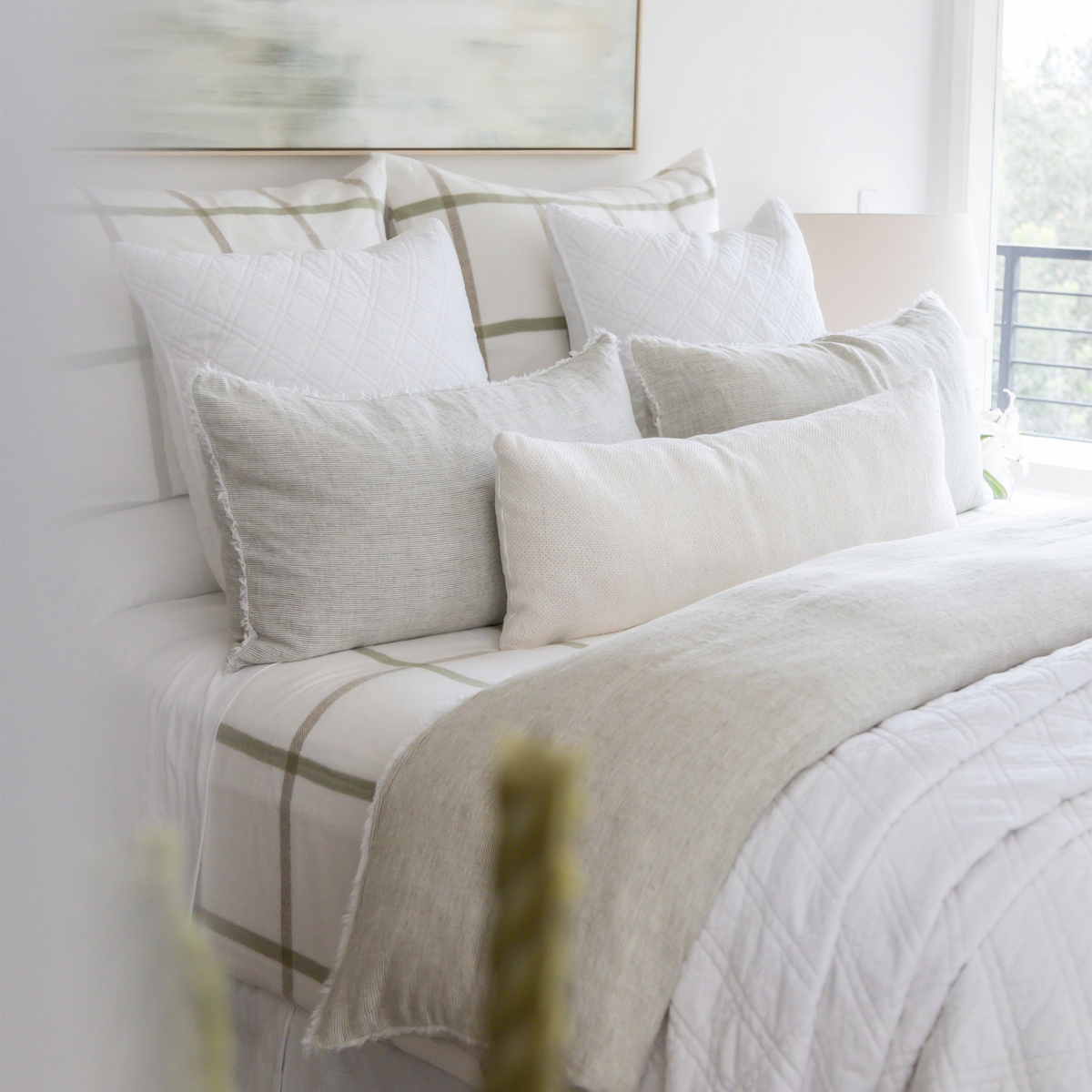 Taupe and white quilted coverlet with plaid stripe border and matching pillows