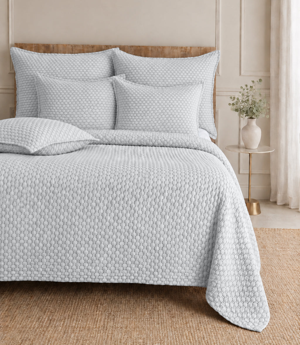 Quilted white bedding set with textured duvet cover and square shams