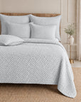 Quilted white bedding set with textured duvet cover and square shams