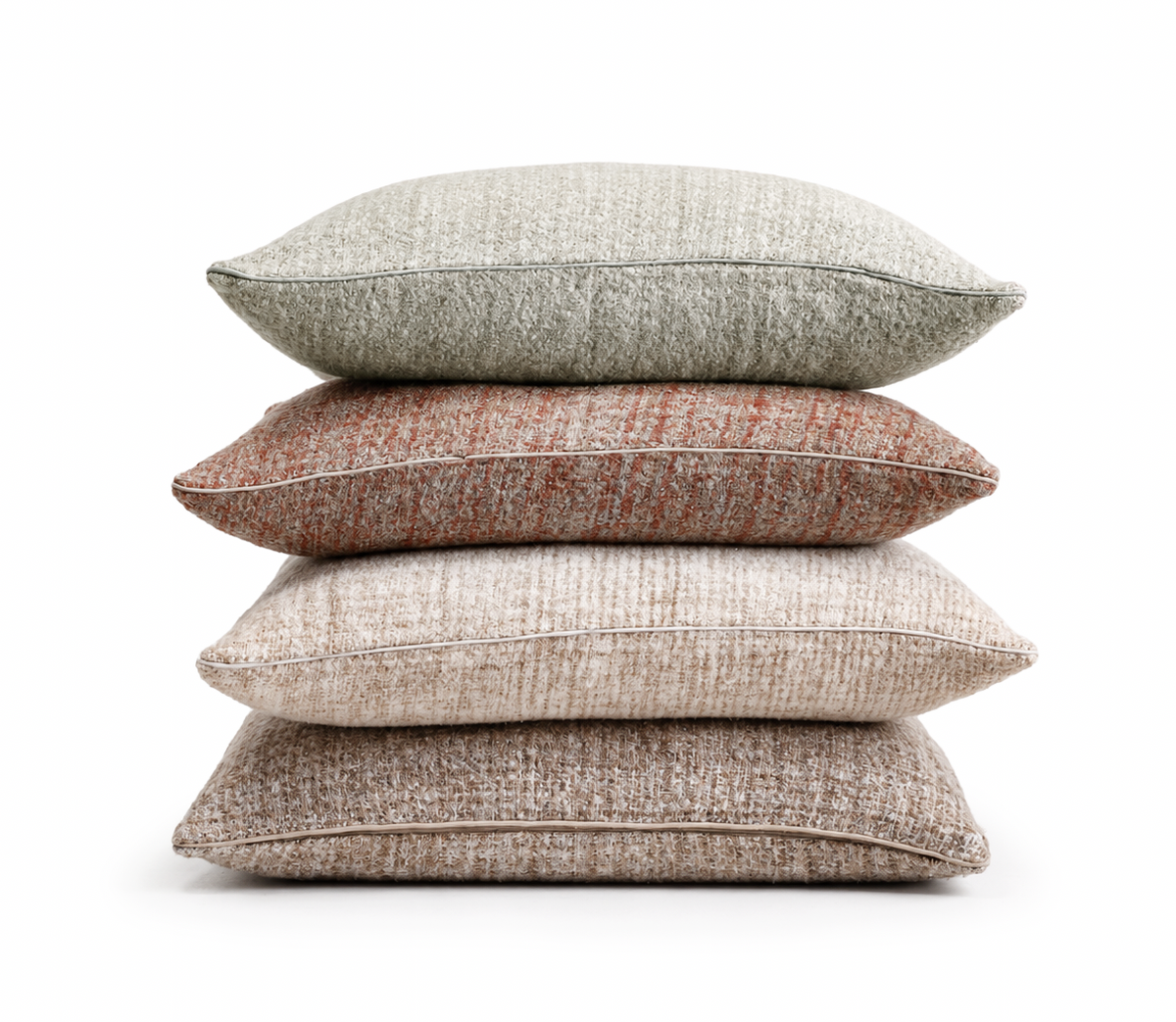 Stack of rectangular decorative pillows: light gray-green, rust, and beige textured covers