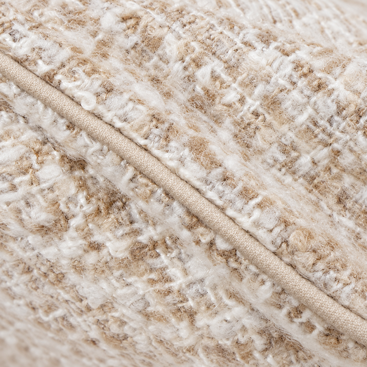Close-up of ivory body pillow fabric with textured woven pattern and trim