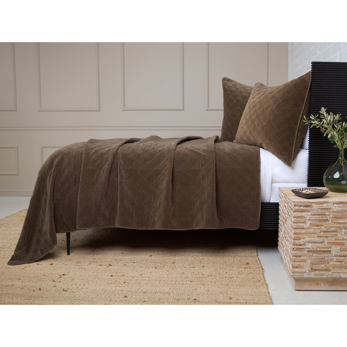Walnut brown quilted coverlet with diamond pattern over a bed with matching pillows.