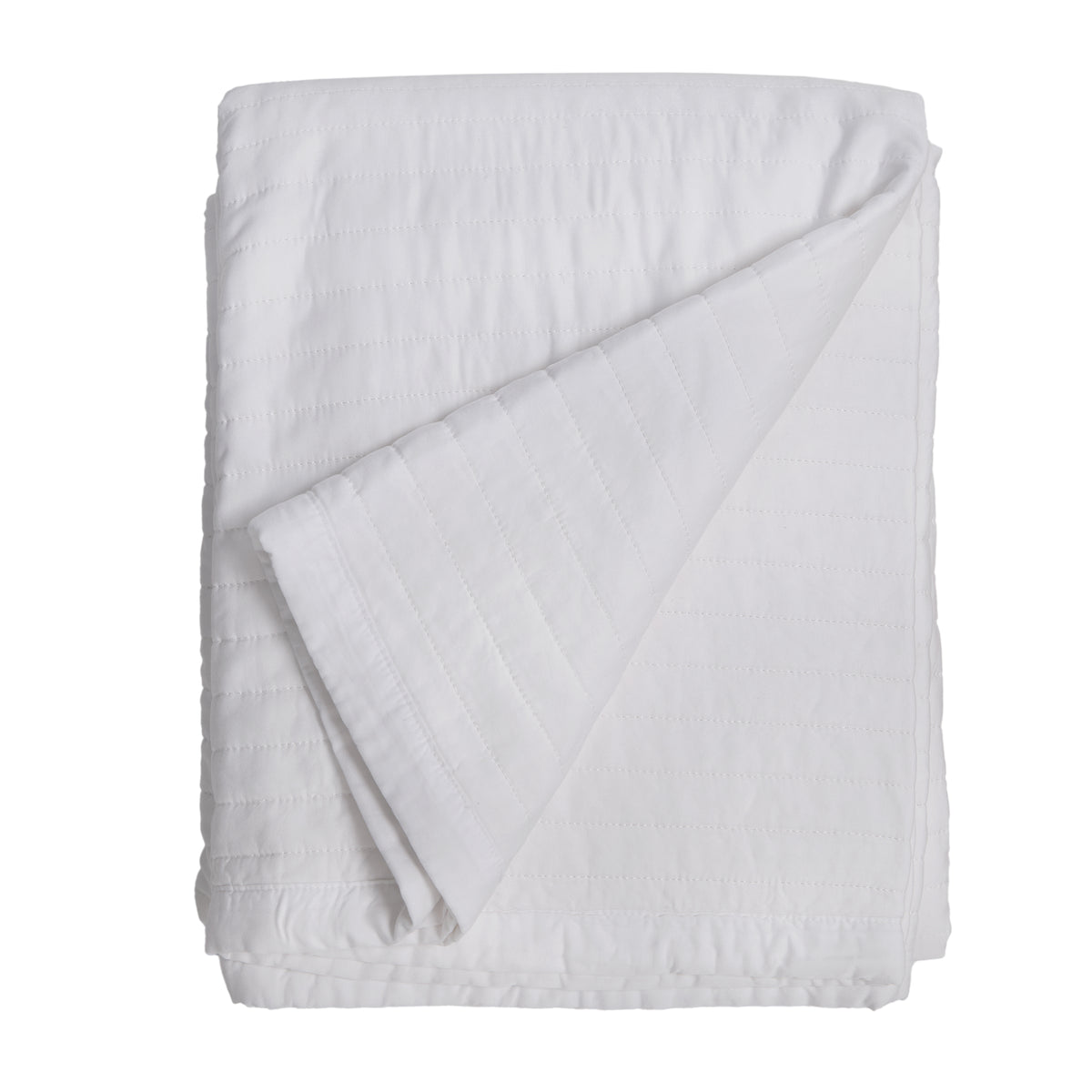 White quilted oversized throw blanket folded with diagonal seam detail