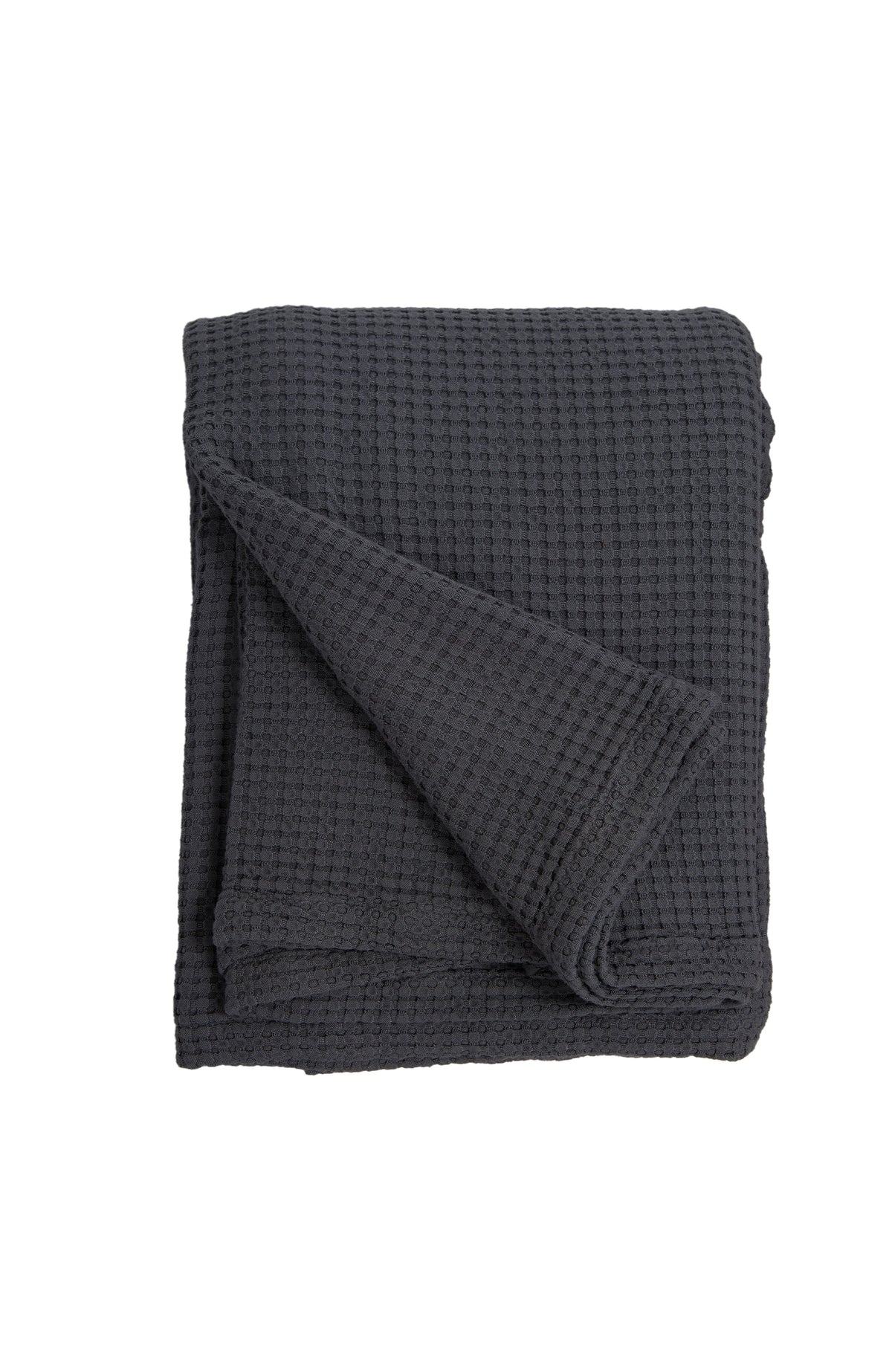 Dark navy waffle-knit oversized throw blanket, folded with diagonal drape on a white background.