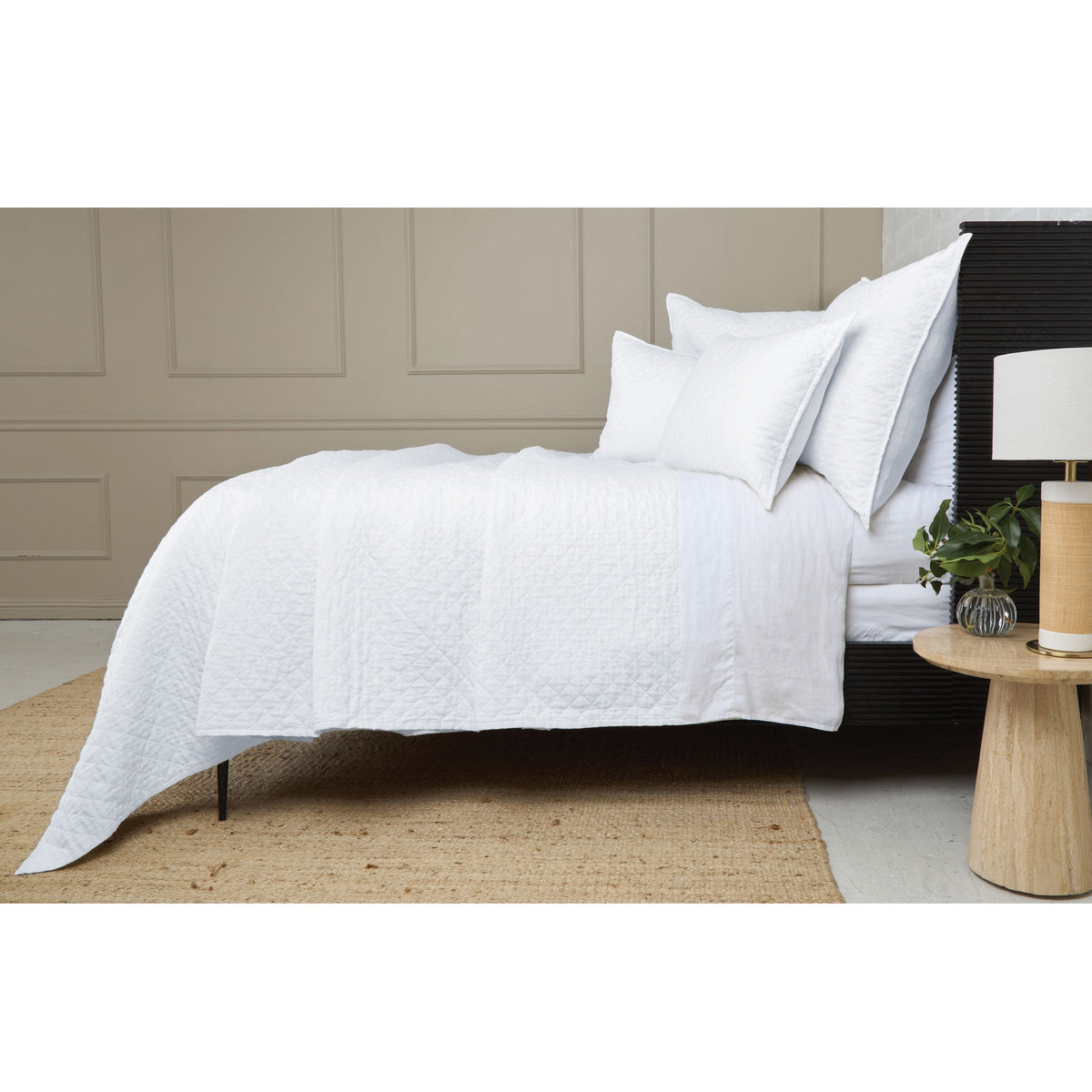 White quilted coverlet set with diamond quilting, falling in soft folds