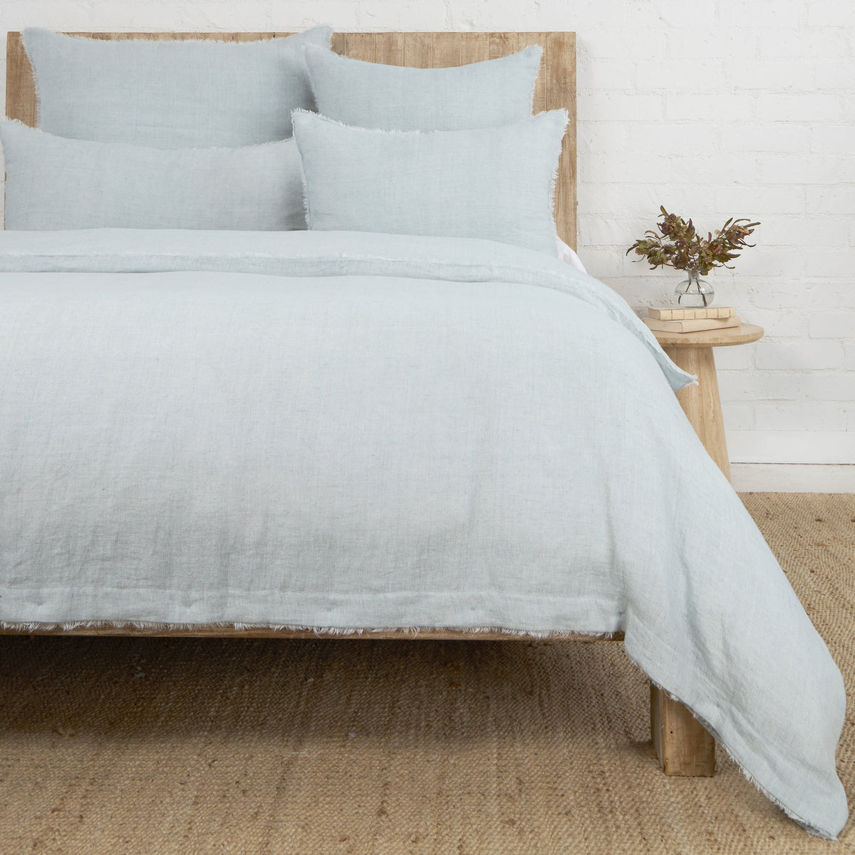 Light blue duvet cover with matching pillow shams, textured fabric and frayed edges