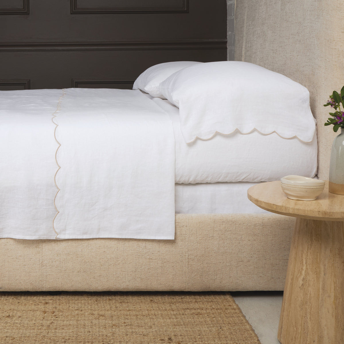 White linen sheet set with scalloped edge and pale blue trim
