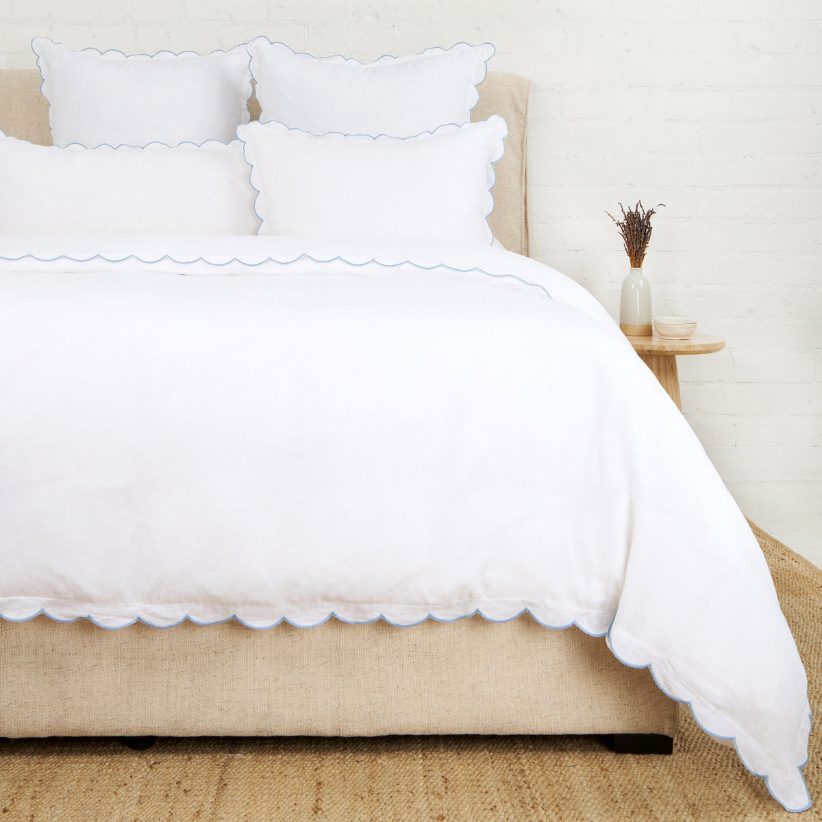 White scalloped duvet cover with layered pillow shams