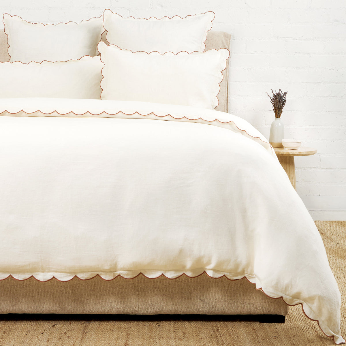 White duvet cover with scalloped edges and matching pillow shams