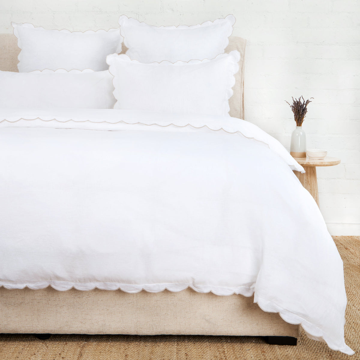 White scalloped duvet cover and pillow shams on bed
