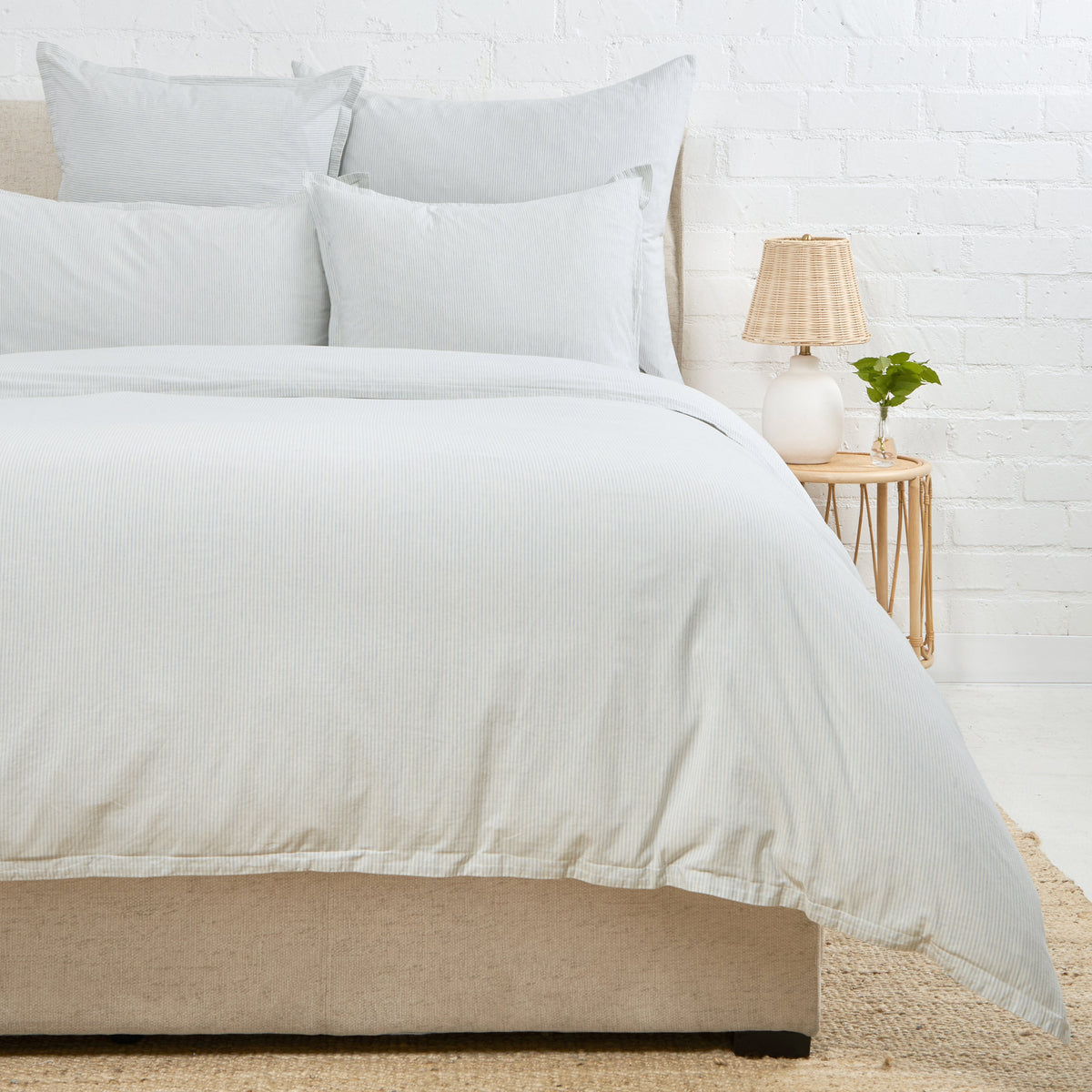 Natural duvet cover on bed with two matching shams, off-white fabric
