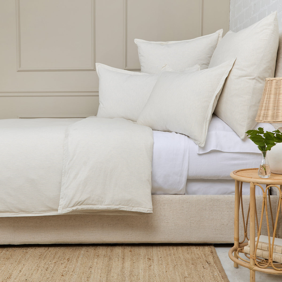 Natural duvet cover with smooth off-white finish and square decorative pillows