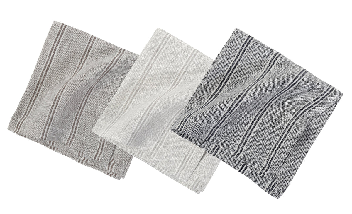 Three folded striped linen napkins in grey tones with vertical bands