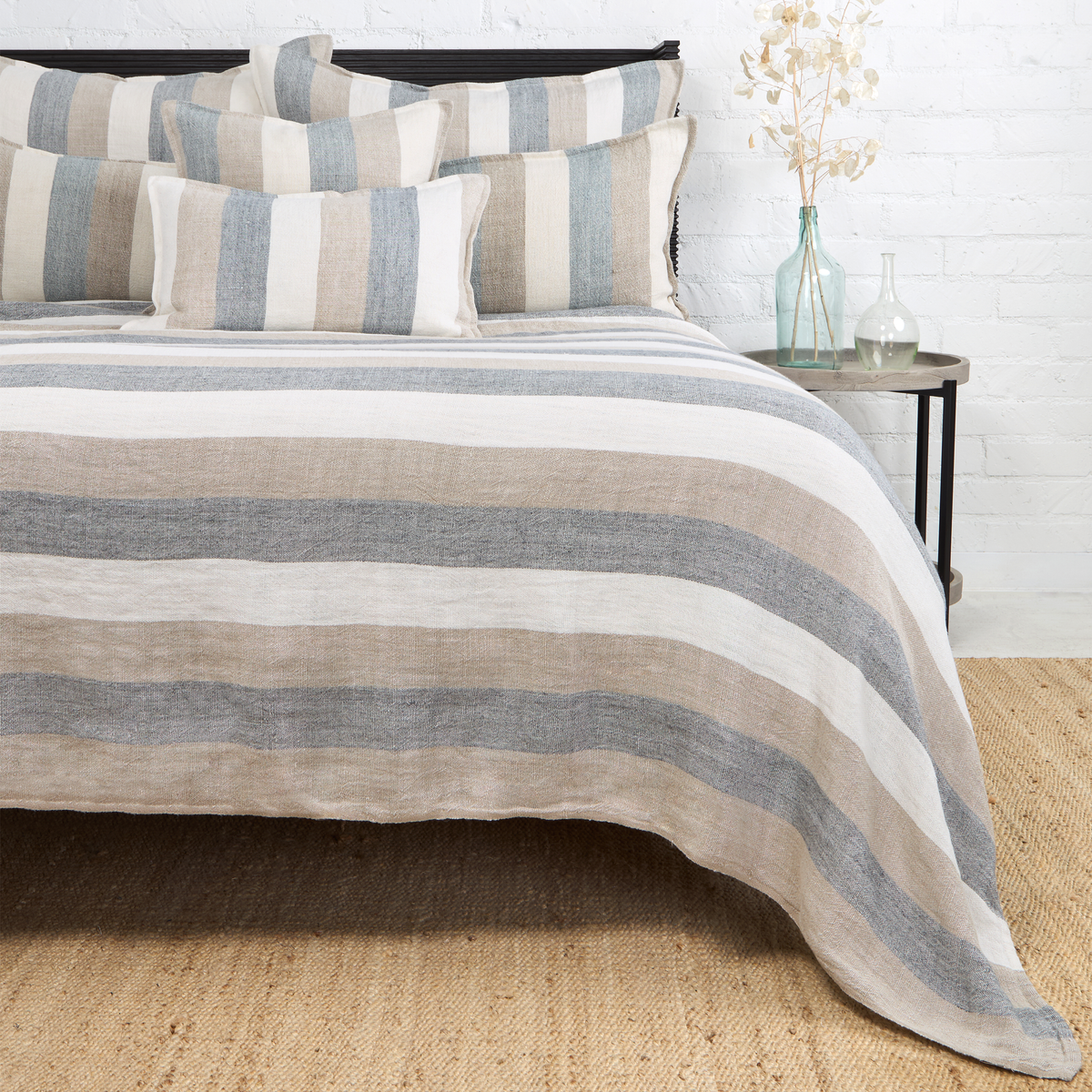 Striped blanket with blue and beige horizontal bands, textured woven fabric