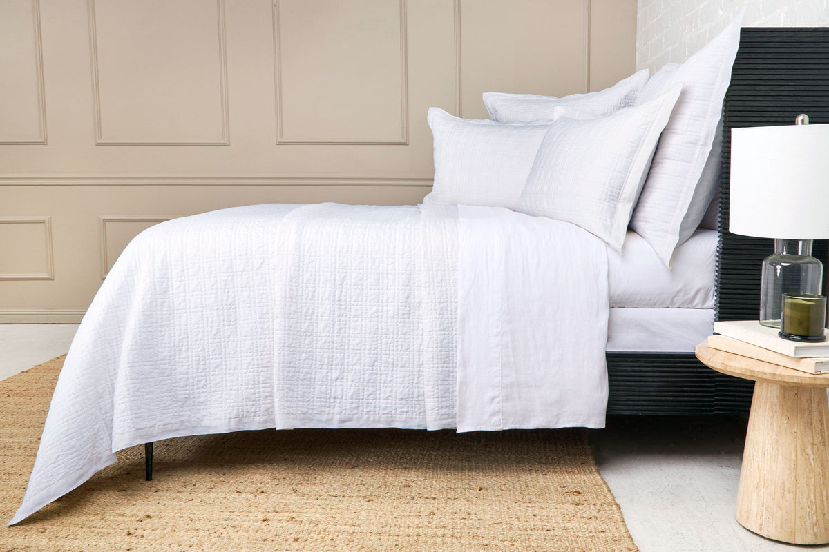 Owen quilted coverlet in white with smooth drape and repeating stitched pattern