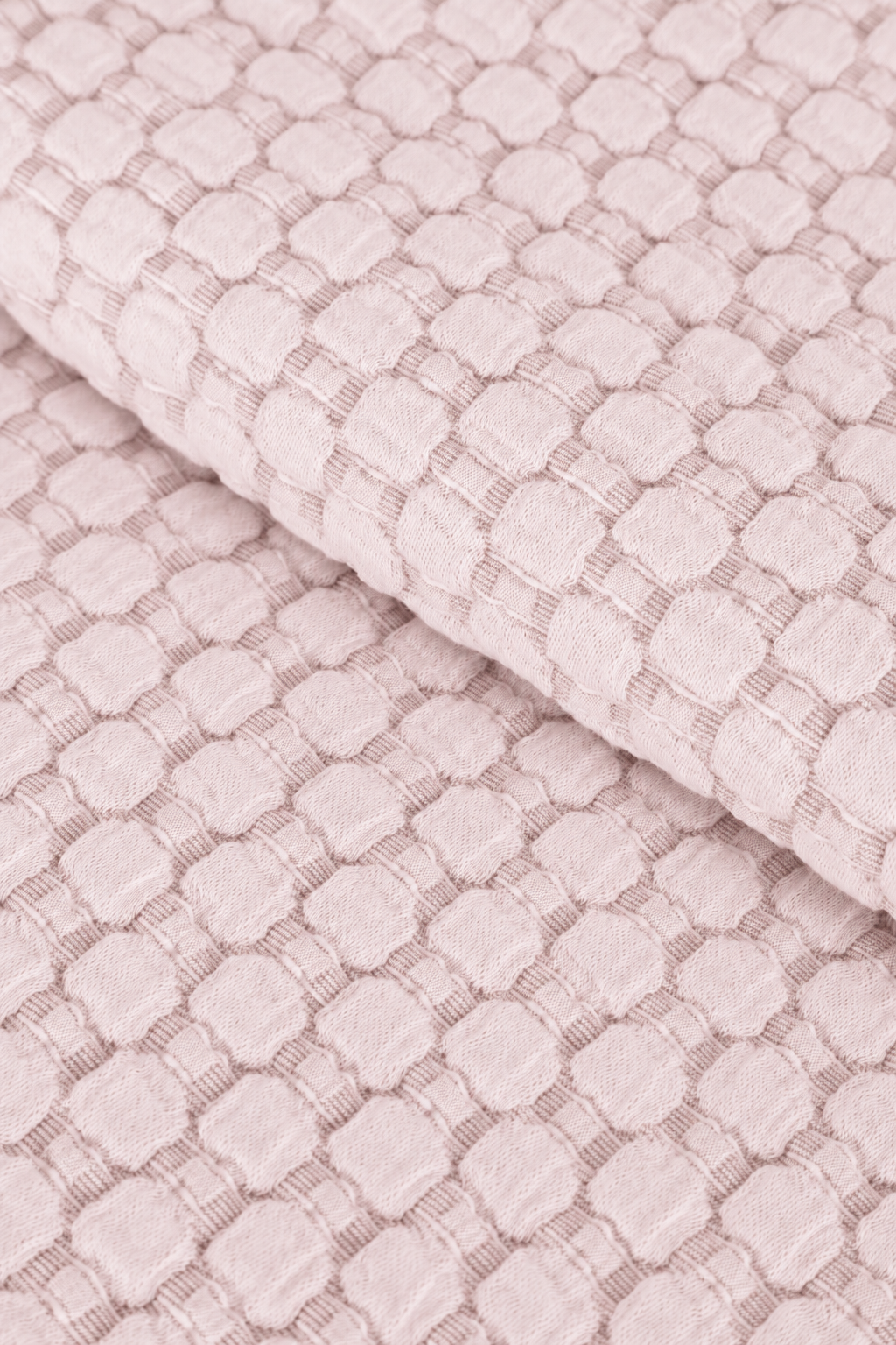 Light blush matelasse quilt fabric with raised geometric lattice texture