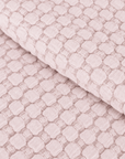 Light blush matelasse quilt fabric with raised geometric lattice texture