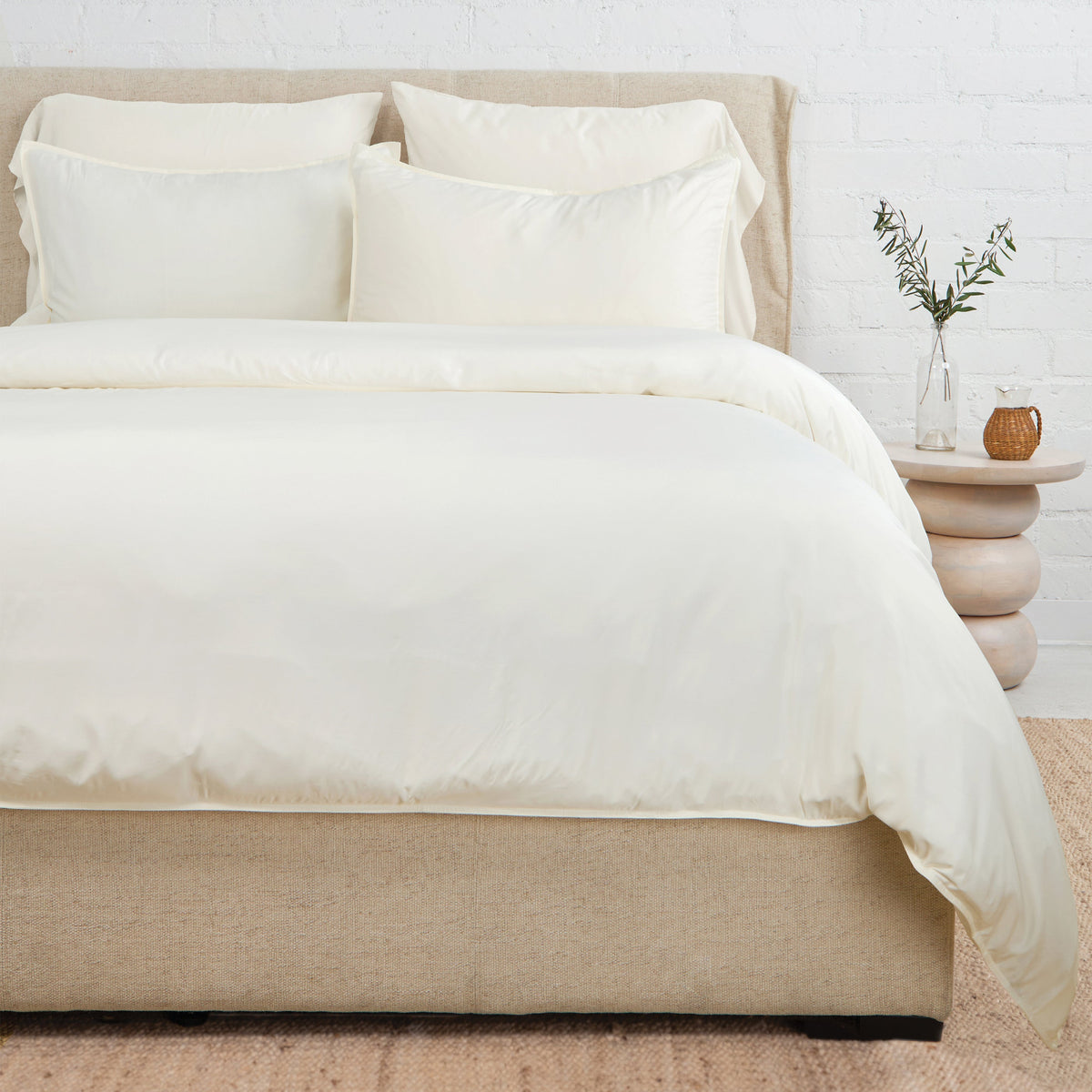 Ivory bamboo sateen duvet set with two pillow shams on a styled bed
