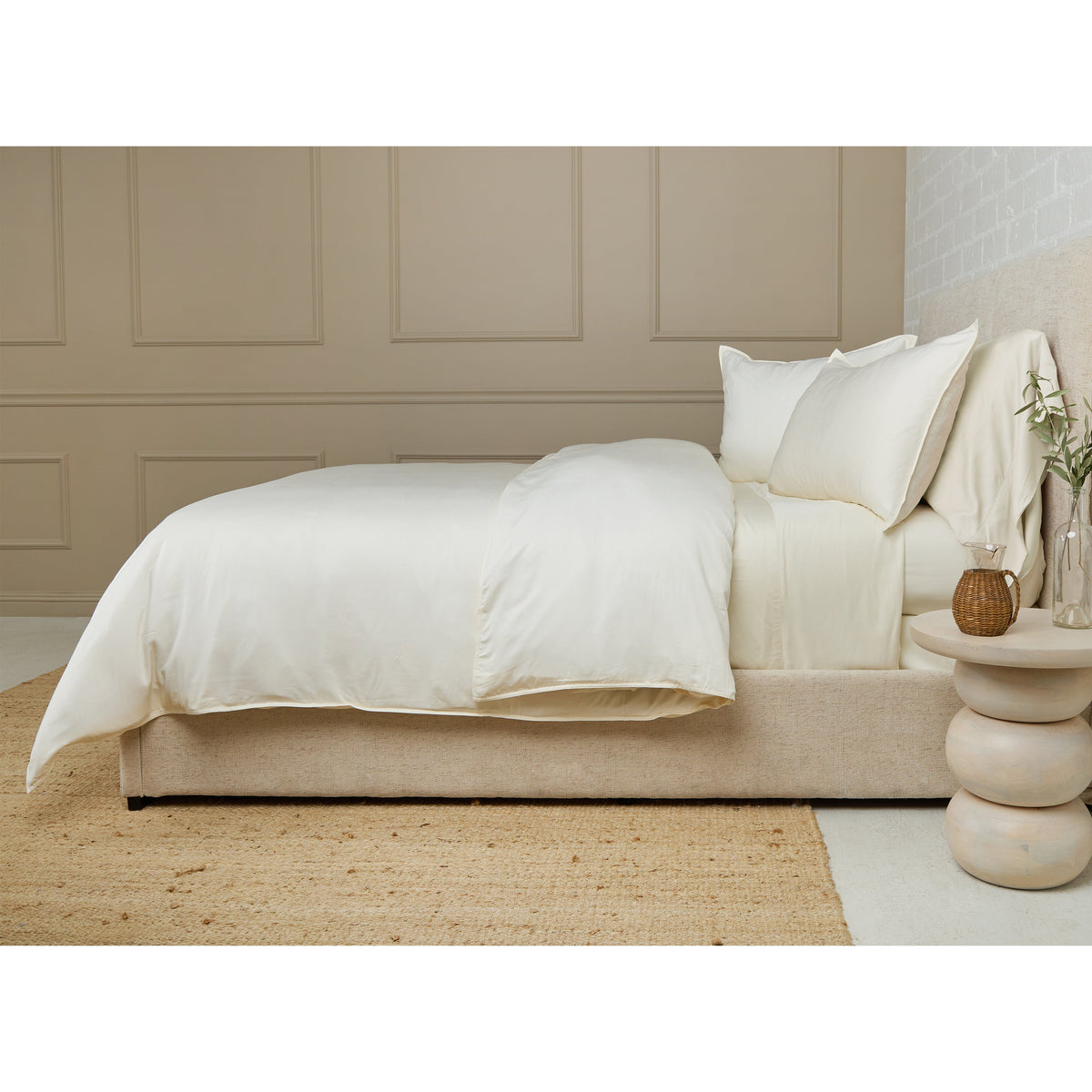 Ivory bamboo sateen duvet set on bed with two pillow shams and smooth duvet