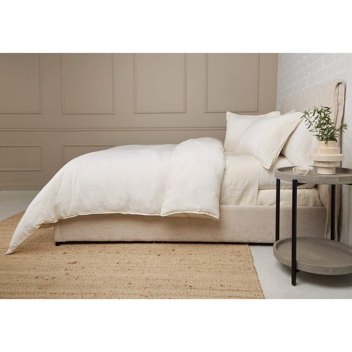 Linen duvet set with white duvet and matching pillow shams on a bed