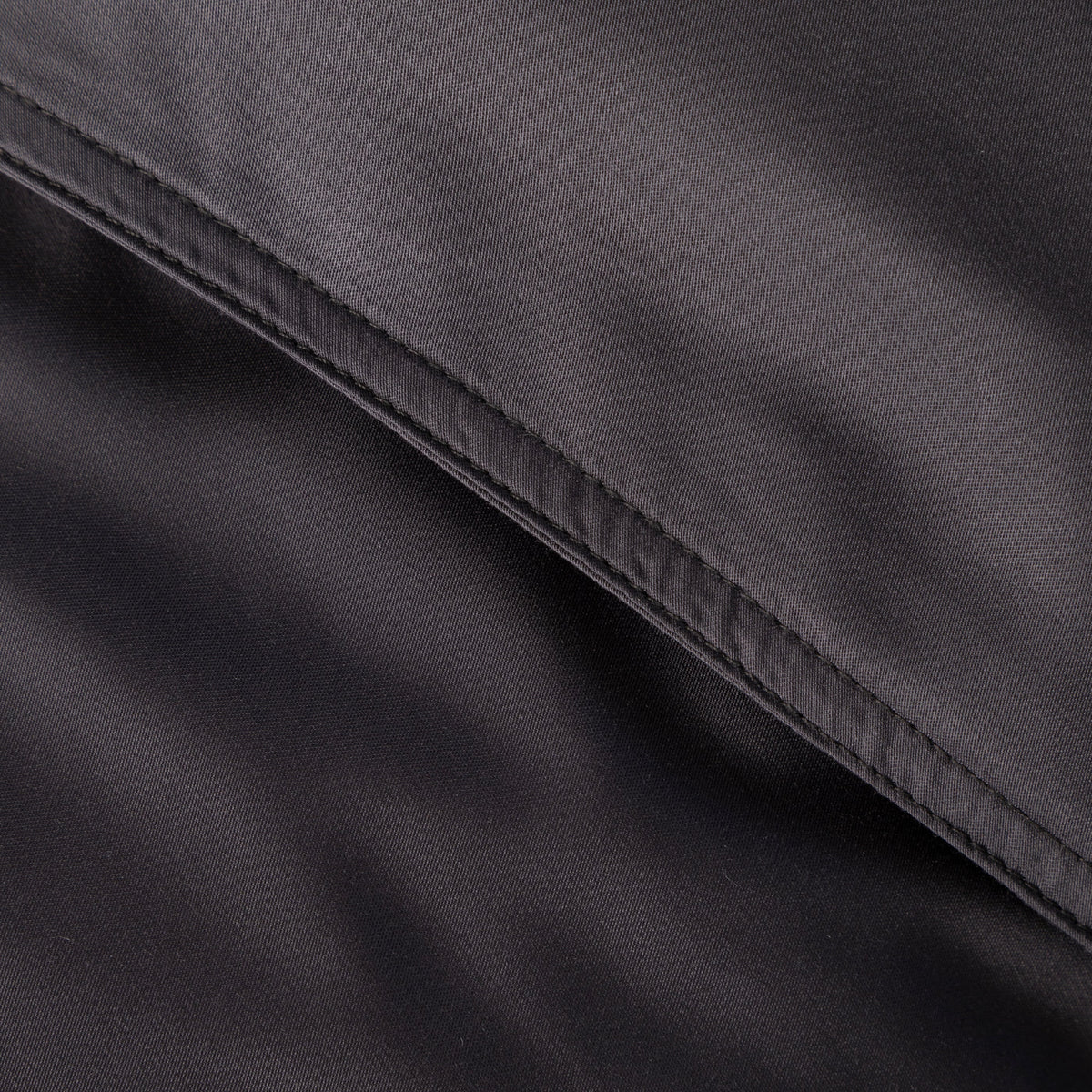 Dark gray bamboo sateen duvet fabric close-up with stitched seam detail