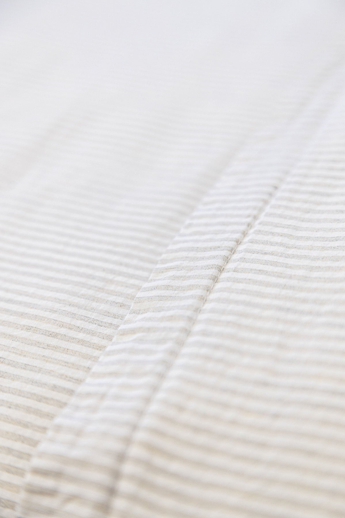 Natural striped duvet cover with subtle diagonal quilting detail