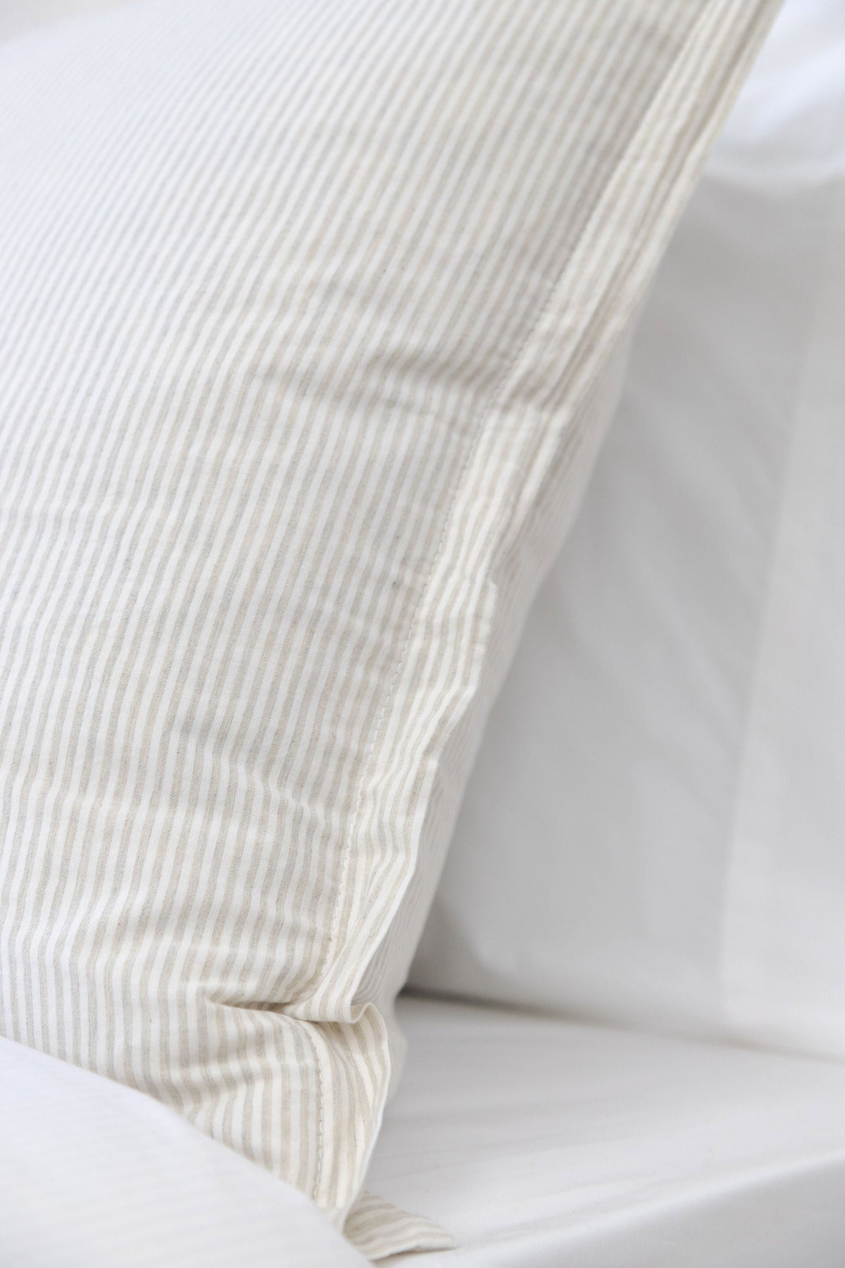 Natural duvet cover corner with stitched border and folded edge