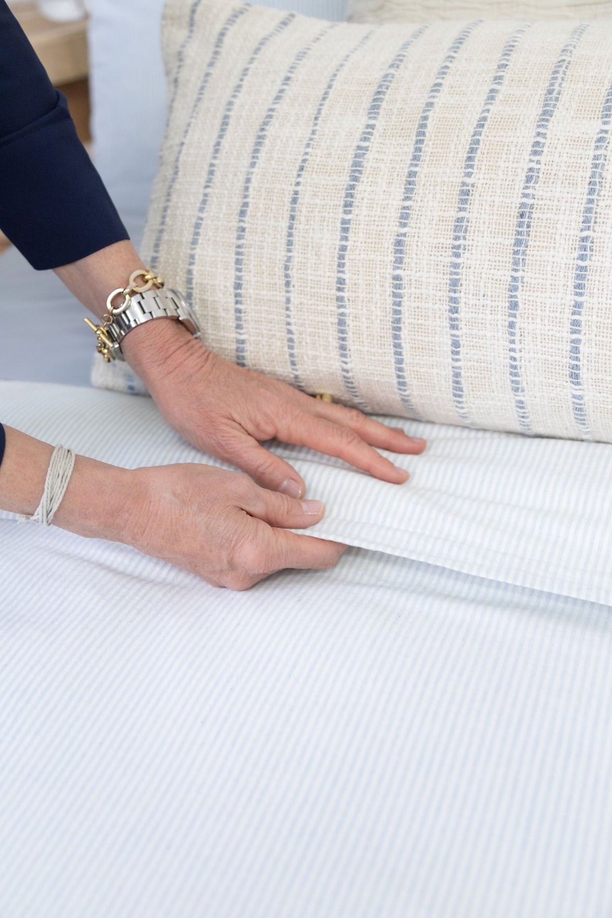 Luke duvet cover on bed with natural and light blue pinstripe fabric