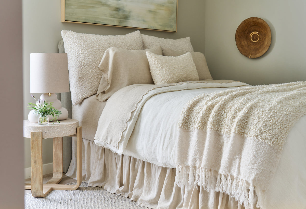 Murphy oversized throw on bed, ivory boucle and white layer with long fringe