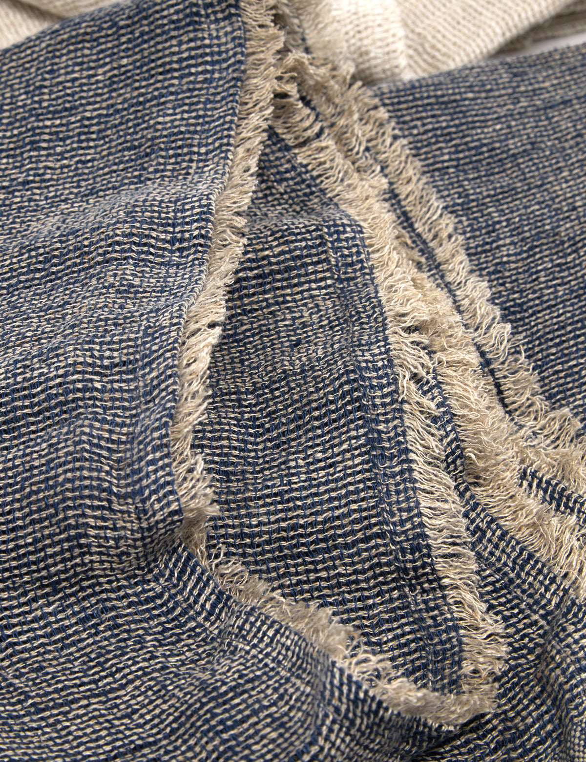 Navy-and-cream woven throw blanket texture with light fringed trim