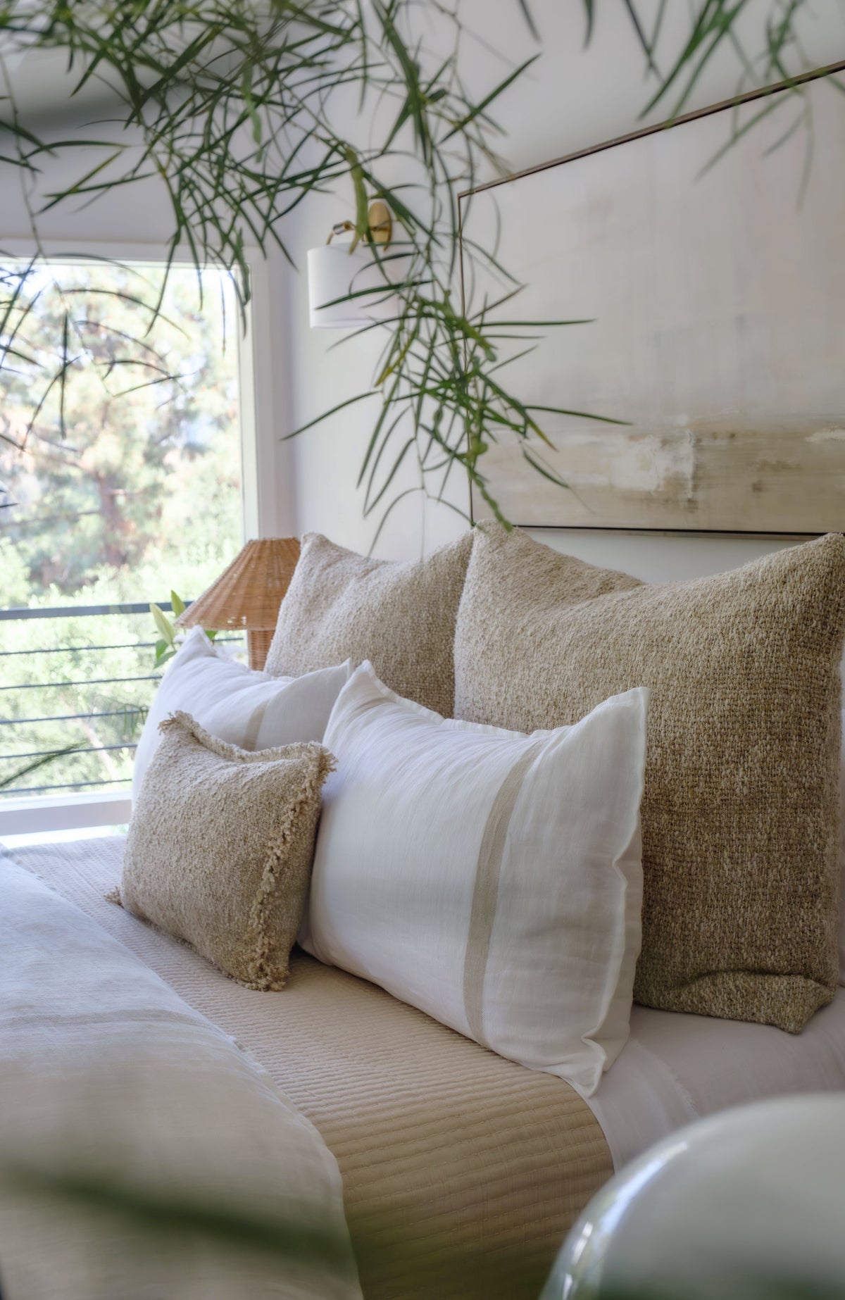 White duvet cover with tan stripe border and stone-colored textured pillows