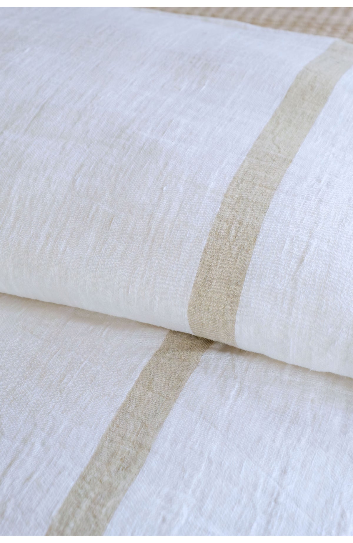 White duvet cover with textured tan stripe band across the fabric surface