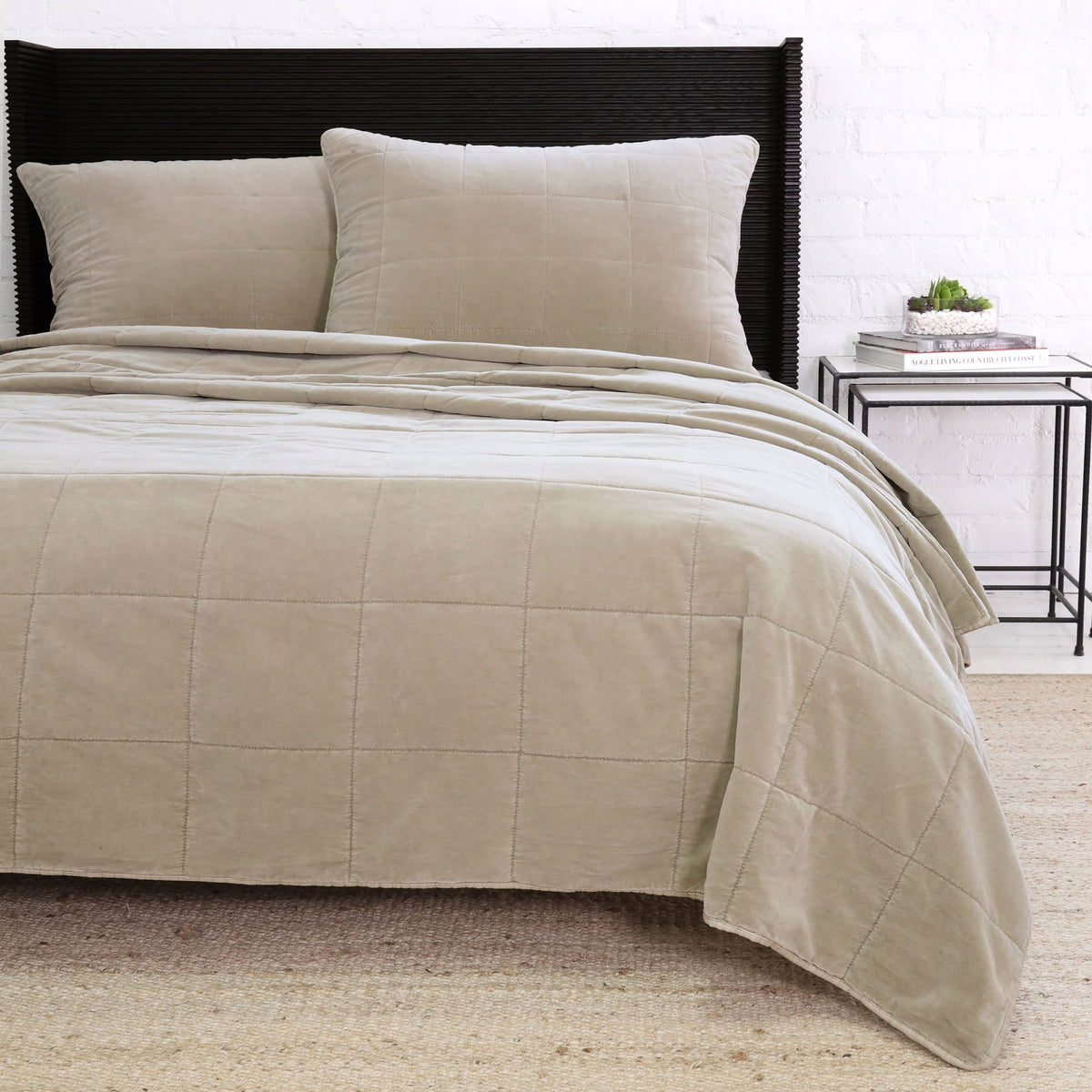 Large 28x36 decorative throw pillow with insert, taupe quilted grid, shown on bed