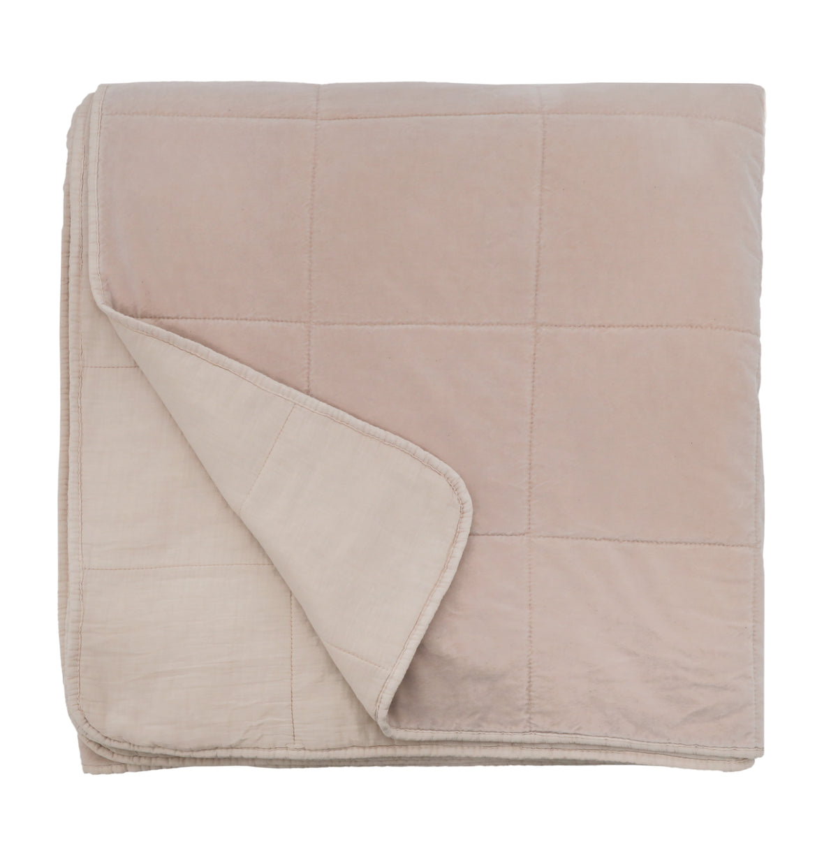 Oversized throw blanket in blush, folded with stitched quilted grid and soft edge