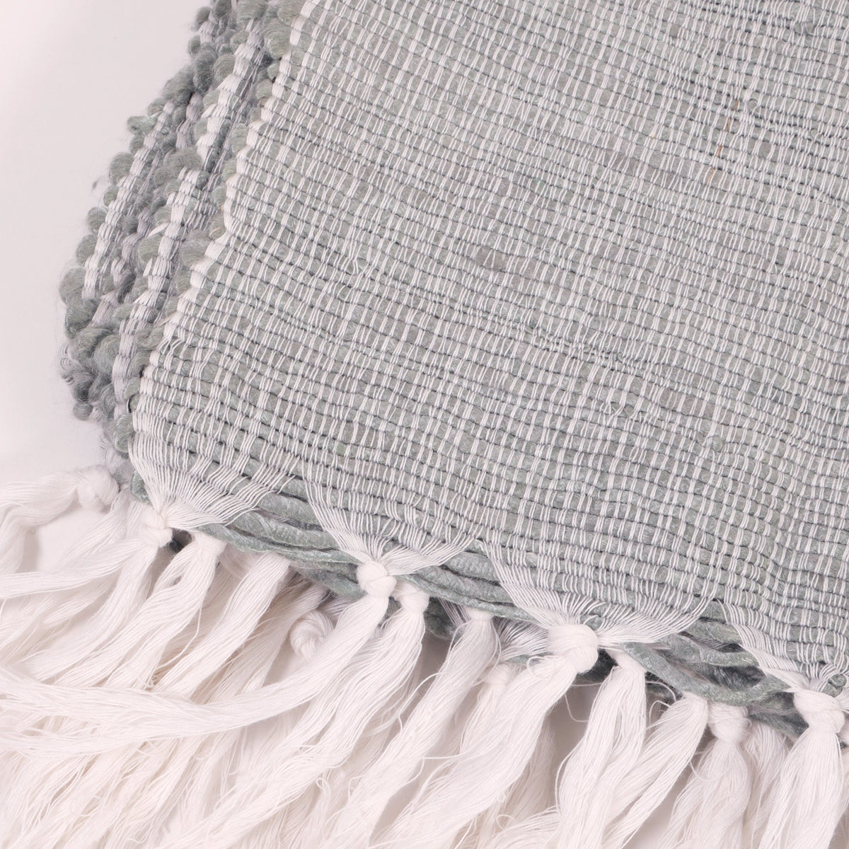 Shore Blue throw close-up of textured weave with white tassel fringe