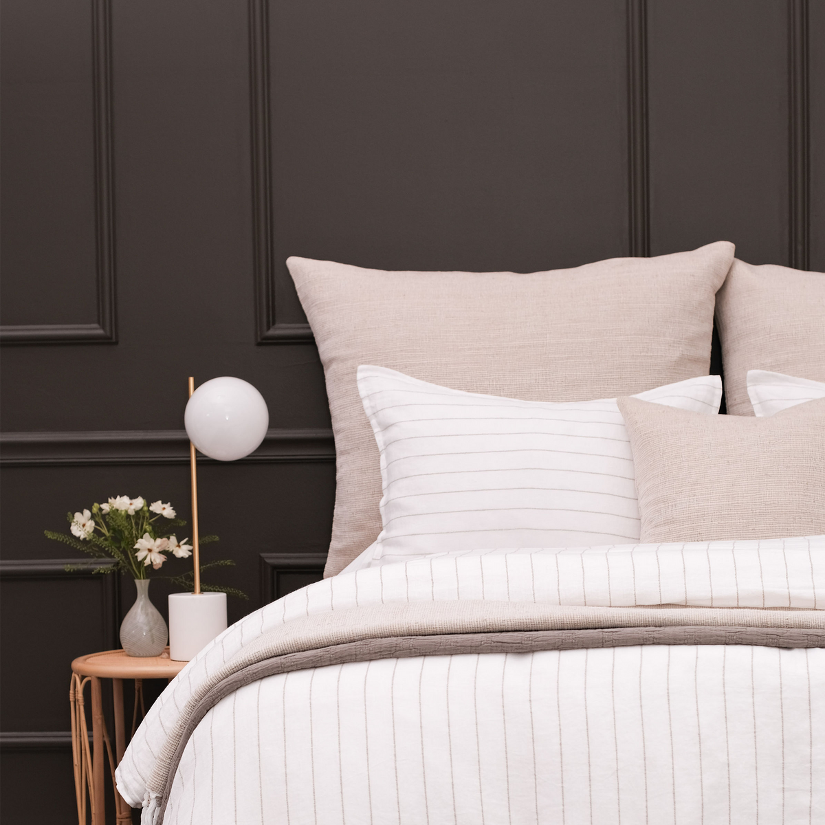 Natural big lumbar pillow set on bed with visible woven cover and square shape