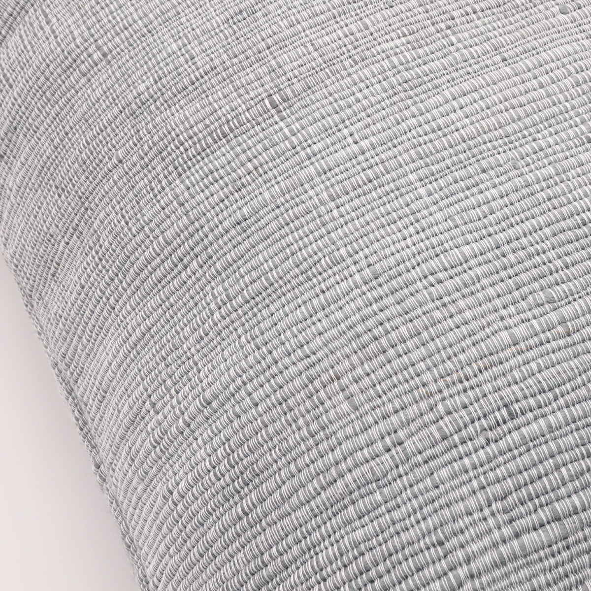 Light blue-gray big lumbar pillow close-up showing fine woven fabric texture