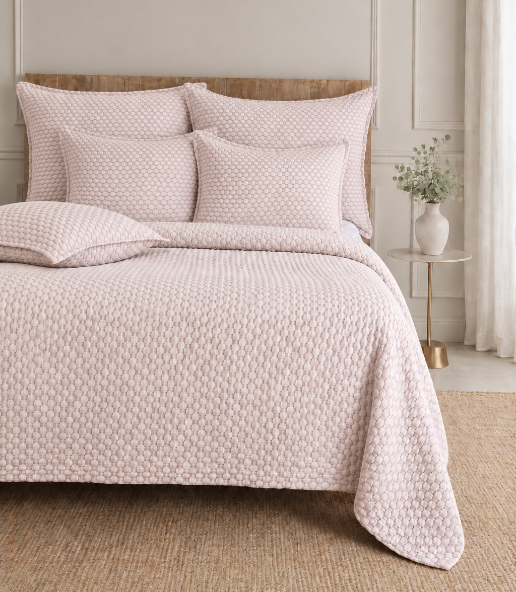 Quilted blush bedding set with textured duvet cover and two square shams