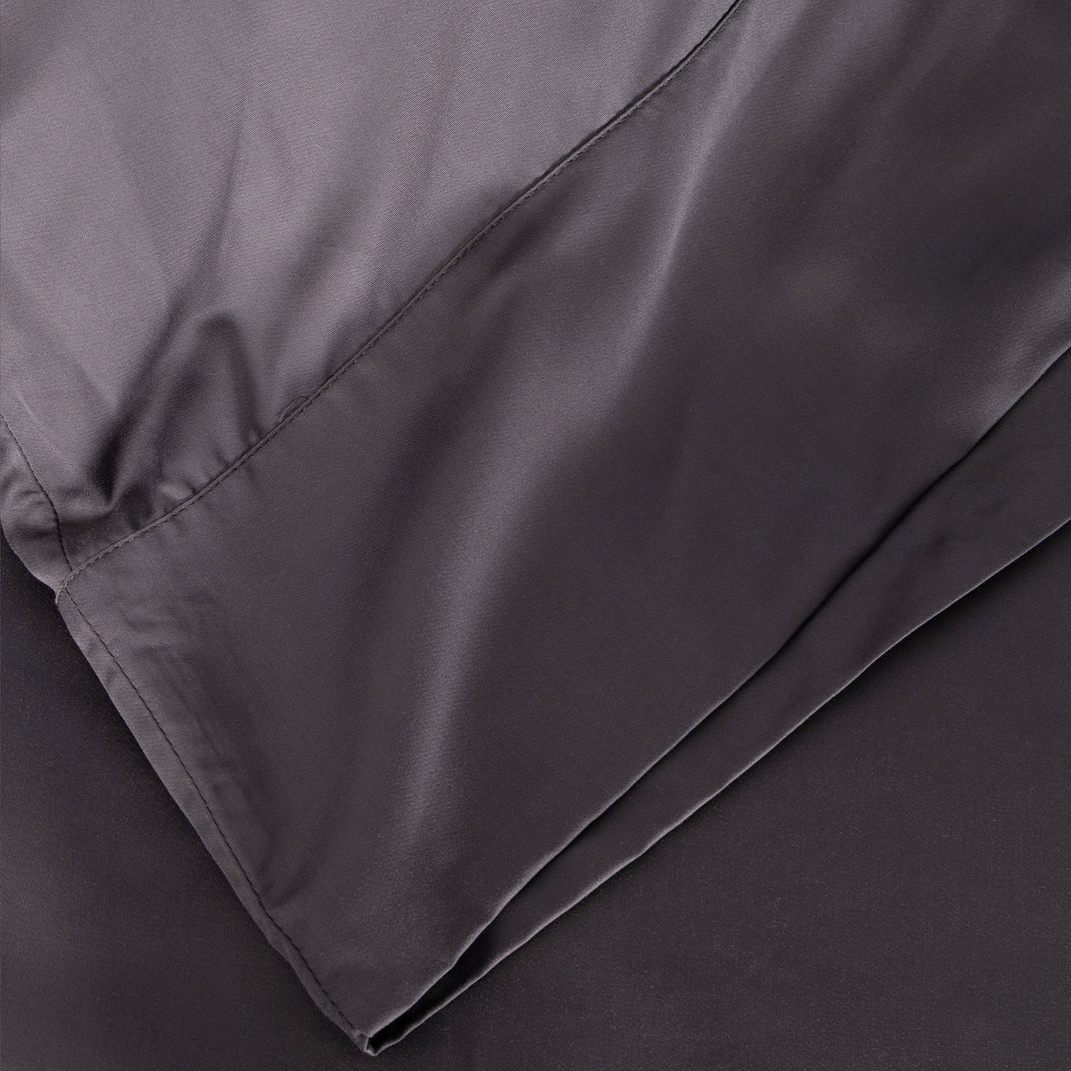 Close-up of dark gray bamboo sateen pillowcase fabric and seam stitching